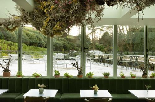 a restaurant with a green couch and tables at Saltmoore in Whitby