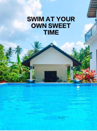 an image of a swimming pool in front of a house at Captain's Cabin Resort - Naval Heritage (Swimming Pool) in Kota Bharu