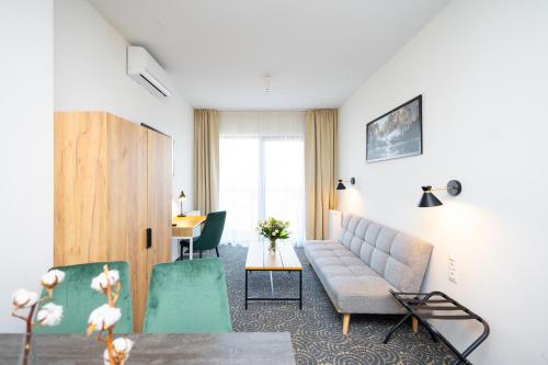 a living room with a couch and a table at Hotel ARDEN in Środa Śląska