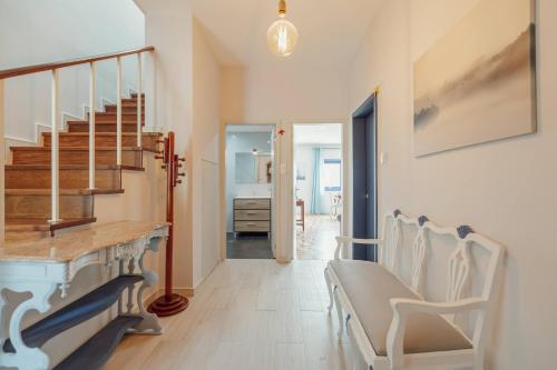 a hallway with chairs and a staircase in a house at Blue Villa by Hosty in Porto