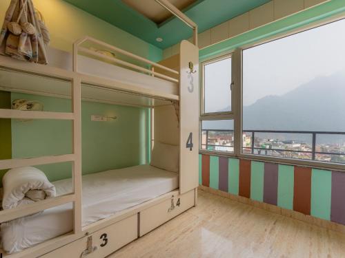 a room with bunk beds and a window at Moustache Rishikesh Luxuria in Rishīkesh