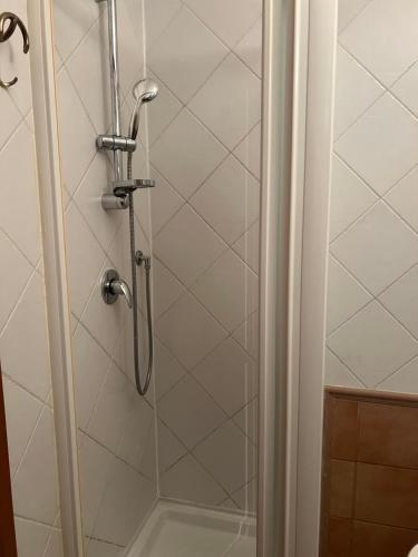 a shower with a glass door in a bathroom at CASA VACANZA Emma in Monfalcone