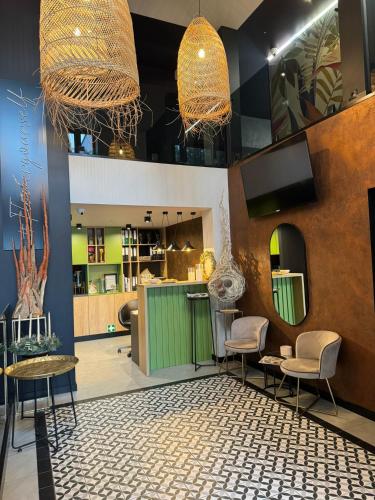 a salon with two chairs and a table and mirrors at Klimatyczne pokoje na Ligonia in Turza Śląska