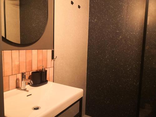 a bathroom with a sink and a mirror at Klimatyczne pokoje na Ligonia in Turza Śląska