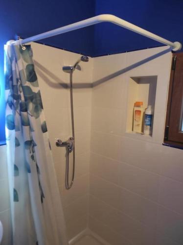 a bathroom with a shower with a shower curtain at La Vía Verde in Jérica