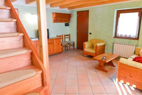 a room with a staircase and a living room at Casa Miramonti in Ossana