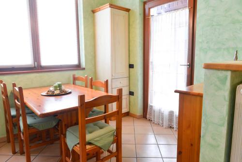 a dining room with a wooden table and chairs at Casa Miramonti in Ossana