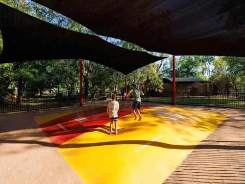 two children are playing in a skate park at Cooinda Lodge Kakadu in Jabiru