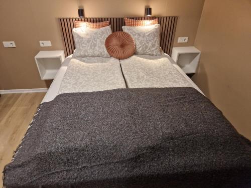 a bedroom with a large bed with two night stands at Black Beach Farm in Vík