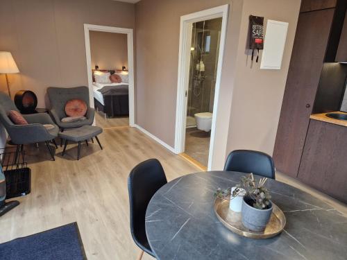 a living room with a table and chairs and a bedroom at Black Beach Farm in Vík