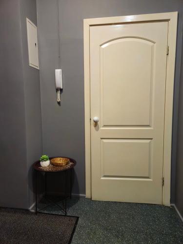 a white door in a room with a table at Heart of Old Riga 3 Bedroom Apartment by Dome Square in Rīga