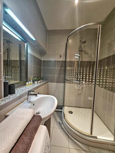a bathroom with a shower and a sink at Heart of Old Riga 3 Bedroom Apartment by Dome Square in Rīga