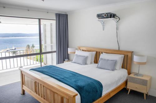 a bedroom with a bed with a view of the ocean at Torndirrup Seascape Awaits in Albany
