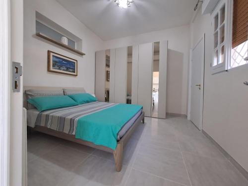 a bedroom with a bed with blue pillows at La casa del Sole in Sava