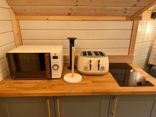 a microwave and a toaster sitting on a counter at Hatton Lodge in Dunkeld