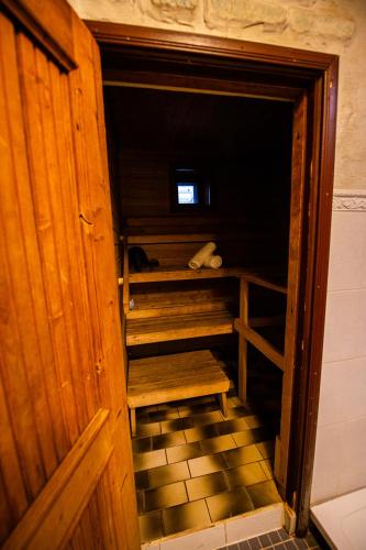 an open door to a room with a wooden closet at Ruunawere Hotel in Nõmmealuse