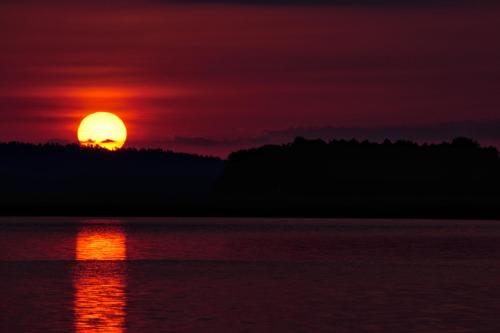 a sunset over a body of water at Centrum One in Suwałki