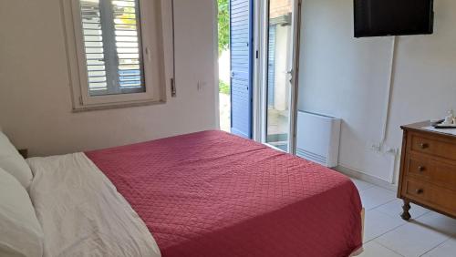 a bedroom with a bed and a window and a dresser at Anninnìa Guest House B&B - GhiIarza in Ghilarza