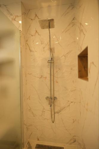 a shower with a shower head in a bathroom at Апартамент за гости Симона in Smolyan