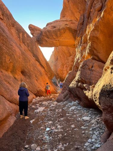 a group of people walking through a canyon at Maison D'hôte La Vallée Des Figues in Tamellalt