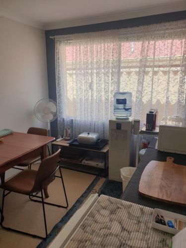 a room with a table and a window and a table and chairs at Telperio - Guest suite max 4 Guests in Bunbury