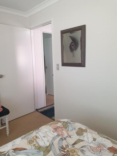 a bedroom with a bed and a picture on the wall at Telperio - Guest suite max 4 Guests in Bunbury