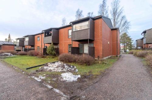 an apartment building with a red brick at Good 3 rooms apartment with free parking & beds for 6! in Helsinki