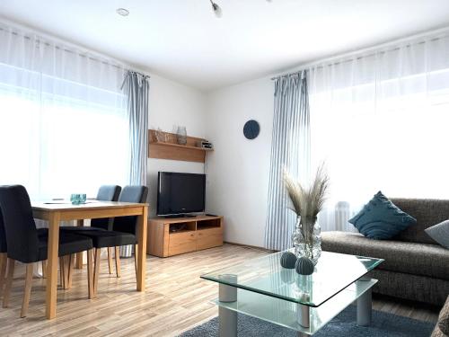 a living room with a couch and a table at Rugenbargsweg 29 Whg 2 in Cuxhaven