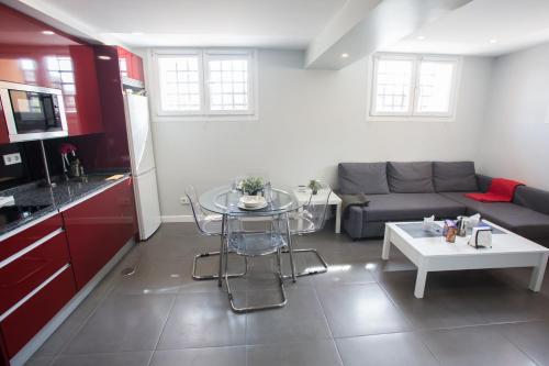 a kitchen and a living room with a couch and a table at WindRose 0 in Madrid