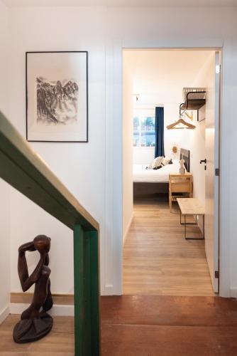 a hallway with a room with a bed and a staircase at L'Atelier - Warm Porto Loft in Porto