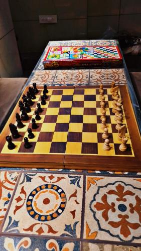 a chess board on a table with a chessboard at Quinte Hills Residency in Panchgani