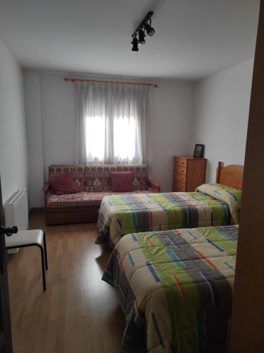 a room with two beds and a couch in it at El Balcón de la Sierra in Mora de Rubielos