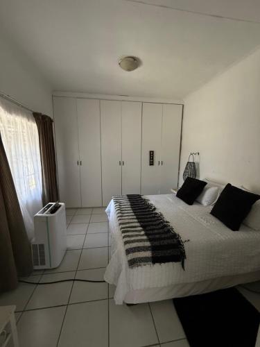 a bedroom with a large bed and white cabinets at Noir & Blanc in Parys