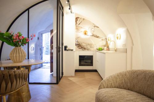 a living room with a table and a chair at The Stork - In luxe logeren aan de Oudegracht, Centrum Utrecht in Utrecht