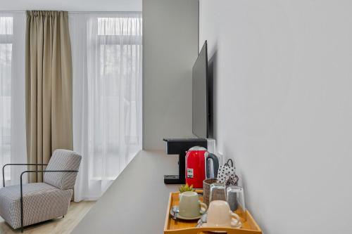 a living room with a coffee table and a chair at Enjoy Apartments and Suites in Zagreb