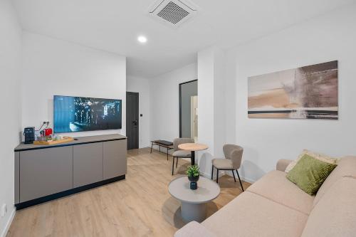 a living room with a couch and a table at Enjoy Apartments and Suites in Zagreb