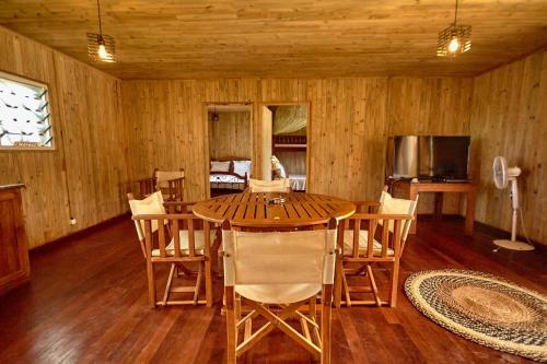 a dining room with a wooden table and chairs at Sunset Madiorano in Tuléar