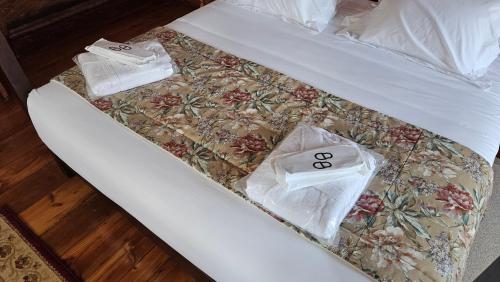 a bed with two plastic bags on top of it at Solar das Tilias - Historic House in Seia