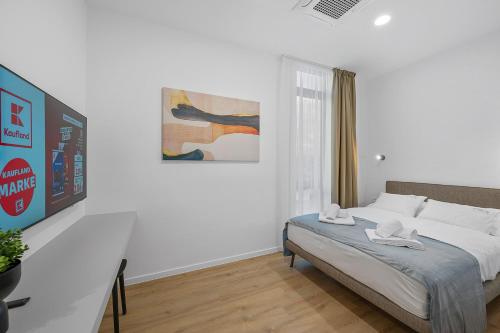 a bedroom with a bed and a painting on the wall at Enjoy Apartments and Suites in Zagreb