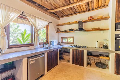 a kitchen with wooden cabinets and a counter top at Casa Laila Cozy House in Bacalar Center in Bacalar