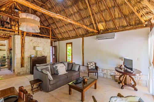 a living room with a couch and a table at Casa Laila Cozy House in Bacalar Center in Bacalar
