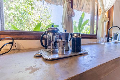 a counter top with two coffee makers on it at Casa Laila Cozy House in Bacalar Center in Bacalar