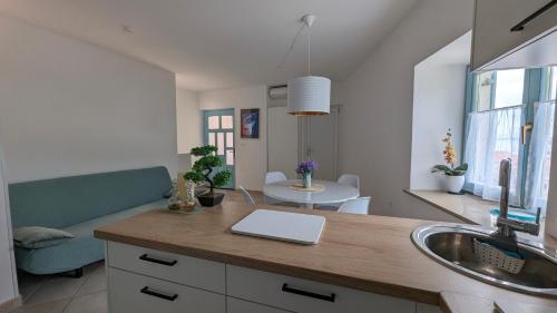 a kitchen with a sink and a laptop on a counter at Ferienwohnung Azur in Selce