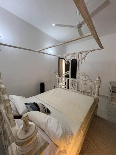 a bedroom with a large bed in a room at Nani Coastal Retreat Modern Bungalow with Terrace in Kilifi
