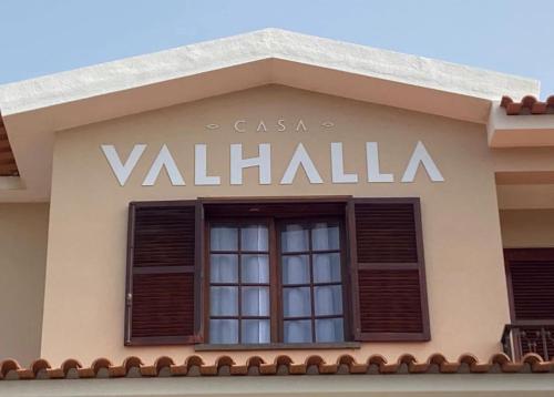 a sign on the side of a building with a window at Casa Valhalla in Funchal