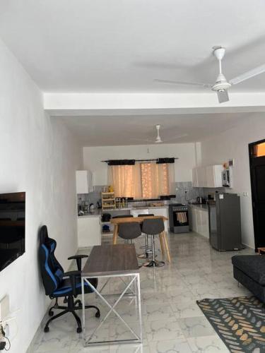 a kitchen and living room with a table and chairs at Nani Coastal Retreat Modern Bungalow with Terrace in Kilifi