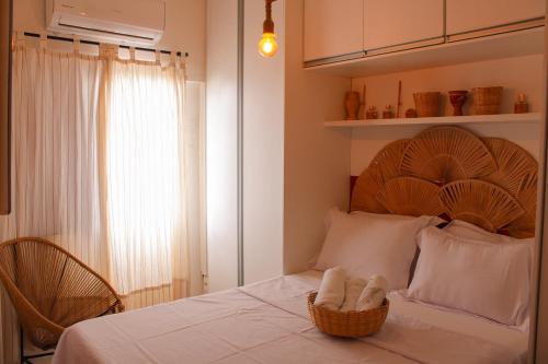 a bedroom with a bed with a basket on it at Axé home - Apartamento conceito em Salvador in Salvador