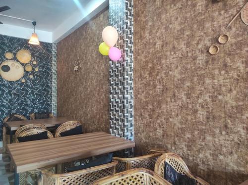 a dining room with a table and some balloons at Rani Guest House in Gauhāti