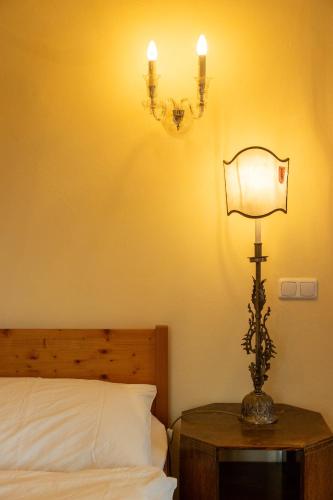 a bedroom with a bed and a lamp on a table at Landhaus im Waldviertel in Zwettl Stadt