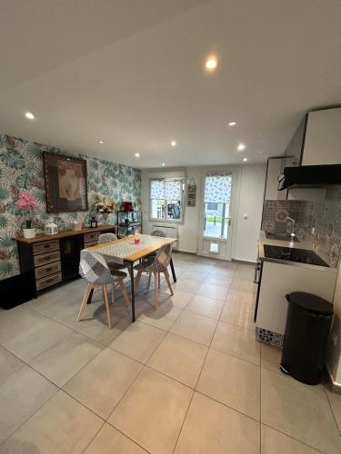 une cuisine avec une table et des chaises dans une pièce dans l'établissement Logement privatif chez l'habitant, à Morangis